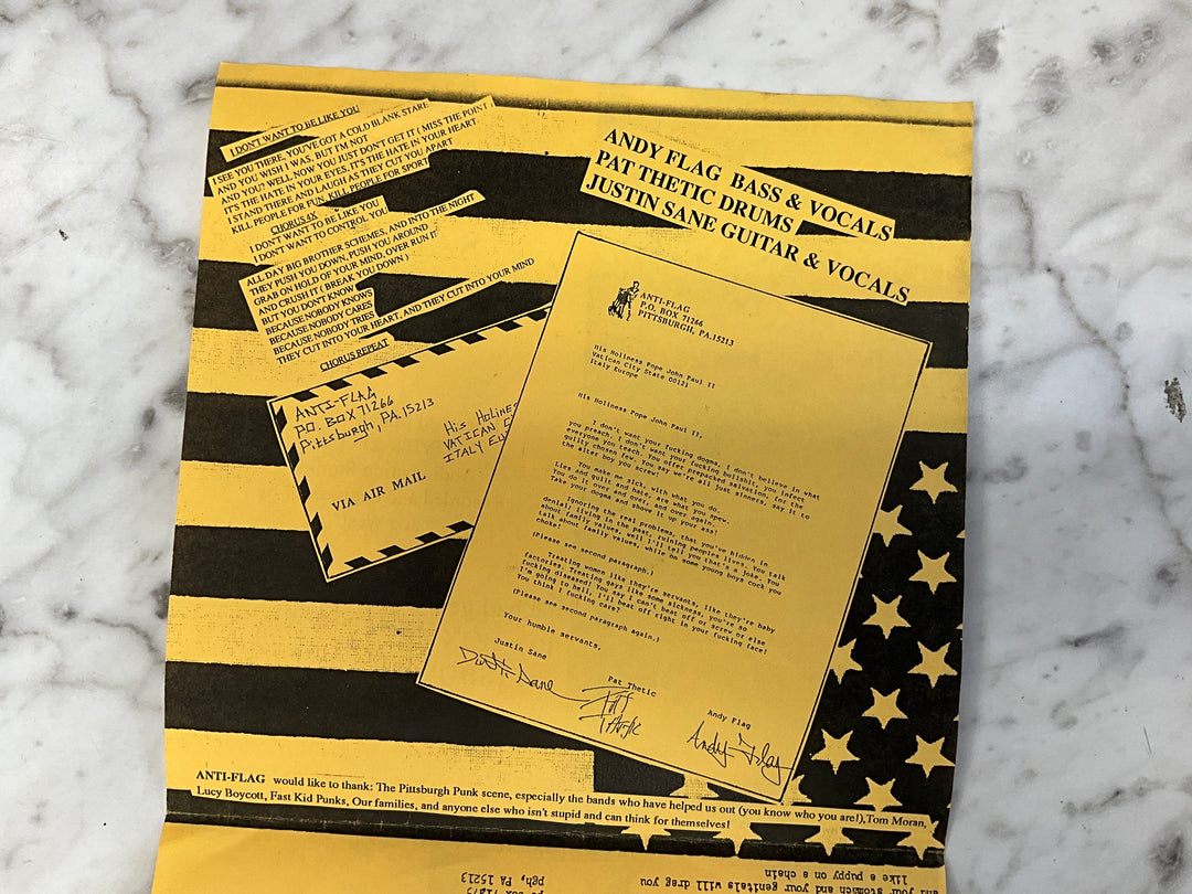 Anti-Flag / The Bad Genes - Rock’n With Father Mike (1994 Yellow Sleeve) Very Good VR101726