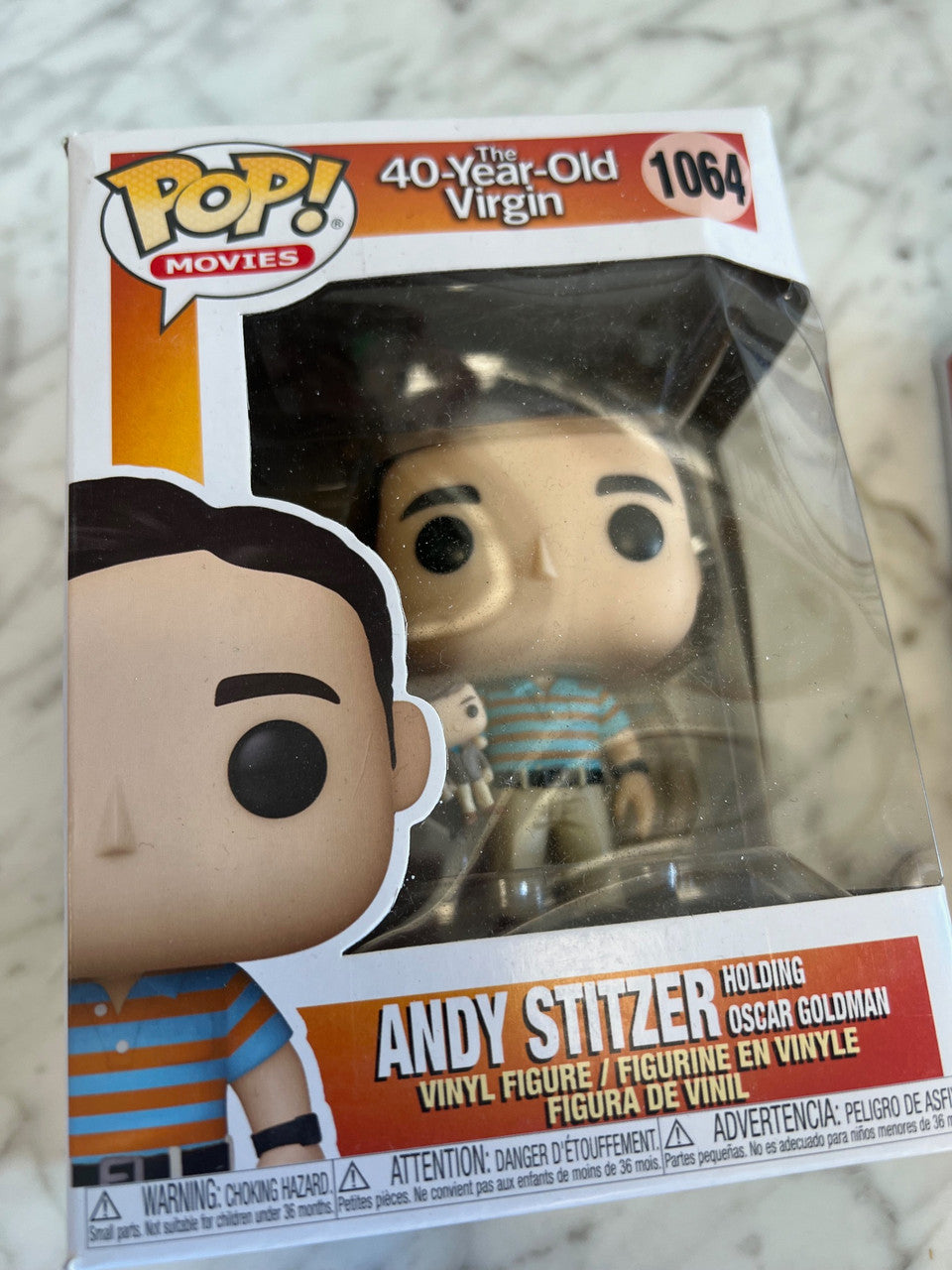 Andy Stitzer holding Oscar Goldman The 40 Year Old Virgin Funko Pop figure 1064